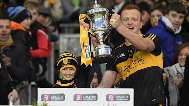 Dr. Crokes supporter Amy O'Connor lifts the Andy Merrigan Cup with captain Johnny Buckley after the 2017 AIB GAA Football All-Ireland Senior Club Championship Final match between Dr. Crokes and Slaughtneil at Croke Park in Dublin. Photo by Brendan Moran/Sportsfile