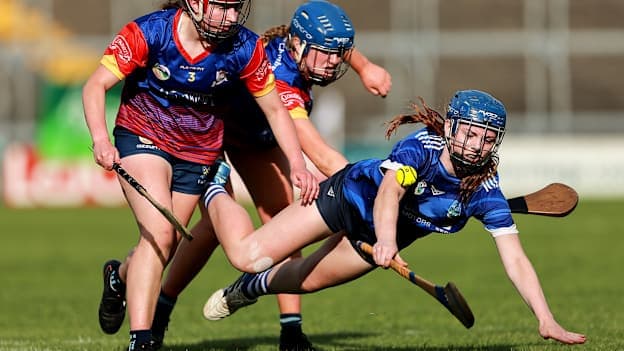 Eilís Bollard of Erin's Own in action against Aibhlin McCarthy, left, and Megan O'Regan of Barryroe during the cup final match between Erin's Own and Barryroe during the 2026 John West Féile na nGael Camogie and Hurling National Finals at Laois Hire O’Moore Park & LOTB Centre Of Excellence in Portlaoise, Laois. Photo by Thomas Flinkow/Sportsfile.