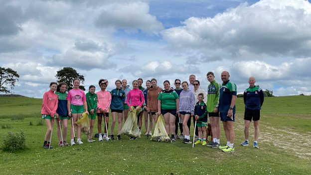 James Barrett pictured with the Sarsfields U-15 camogie players and their coaches who participated in the Curragh litter pick-up project.