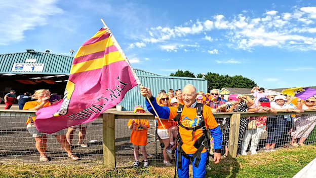 Eamon Kehoe waves a Wexford flag after completing his skydive to raise funds for the Jack & Jill Children's Foundation. Photo courtesy of Irish Parachute Club. 