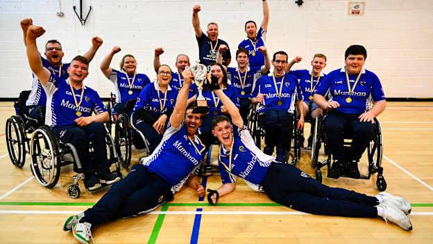 The Munster team, including captain Darren Dineen, front right, lift the cup after their side's victory in the 2024 M. Donnelly GAA Wheelchair Hurling / Camogie All-Ireland Finals at SETU Carlow Campus Sports Hall in Carlow. Photo by Shauna Clinton/Sportsfile