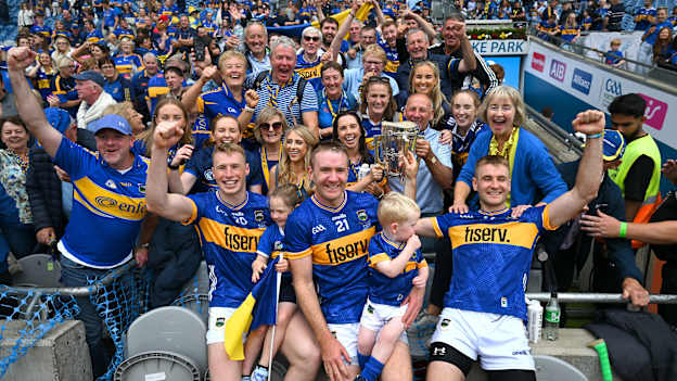 Tipperary brothers, from left, Brian McGrath, Noel McGrath and John McGrath celebrate with the Liam MacCarthy cup and family after their side's victory in the GAA Hurling All-Ireland Senior Championship final match between Cork and Tipperary at Croke Park in Dublin. Photo by Stephen McCarthy/Sportsfile.