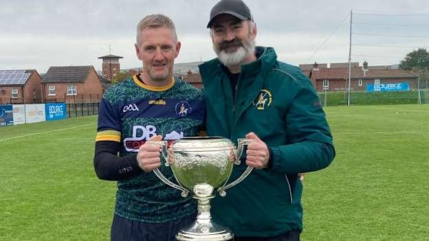 Dr. Ciarán Kearney pictured with Dunloy hurling team manager, Gregory O'Kane, and the Volunteer Cup. 