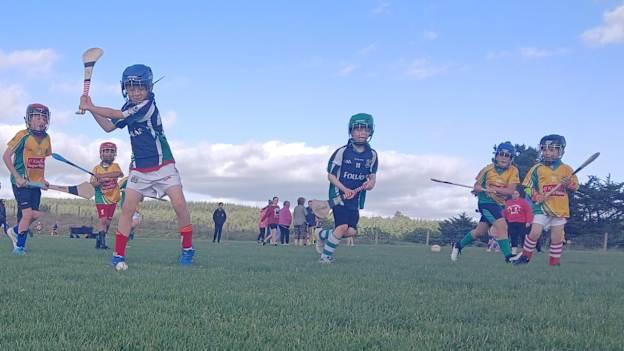 A young Laochra Óg hurler in action. 