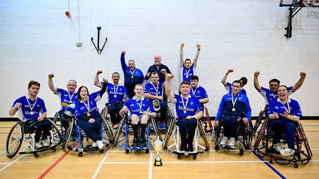 Munster players and staff celebrate with the cup after their victory in the M. Donnelly GAA Wheelchair Hurling & Camogie All-Ireland Finals 2025 final match between Munster and Leinster at SETU Carlow Campus Sports Hall in Carlow. Photo by Ben McShane/Sportsfile.