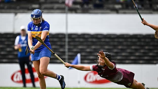 Eimear McGrath of Tipperary shoots to score her side's first goal despite the attention of Dervla Higgins of Galway during the 2024 Glen Dimplex Camogie All-Ireland Senior Championship semi-final match between Galway and Tipperary at UPMC Nowlan Park in Kilkenny. Photo by Harry Murphy/Sportsfile.