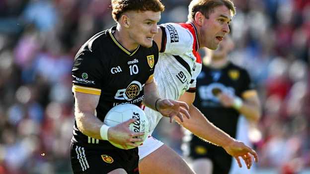 Danny Magill, Down, and Conor Grimes, Louth, in All-Ireland SFC action. Photo by Daire Brennan/Sportsfile
