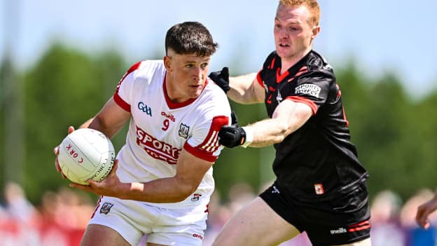 Colm O'Callaghan, Cork, and Donal McKenny, Louth, in All-Ireland SFC action. Photo by Ben McShane/Sportsfile