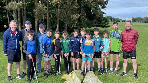 James Barrett pictured with the Naas U14 hurlers and their coaches who participated in the Curragh litter pick-up project.