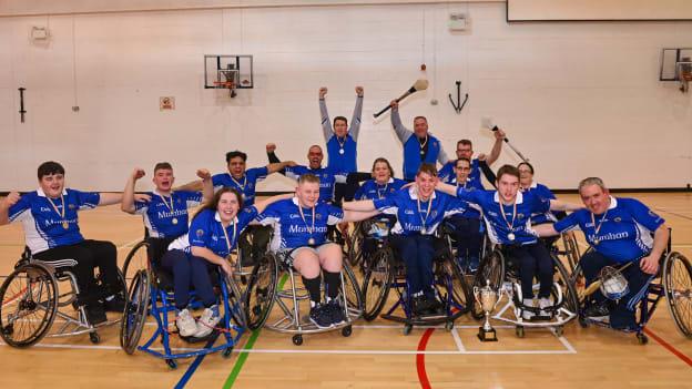 Munster players and staff celebrate with the cup after the 2023 Wheelchair Hurling / Camogie All Ireland Final match between Ulster and Munster at SETU Carlow Sports Hall in Carlow. Photo by Ben McShane/Sportsfile.