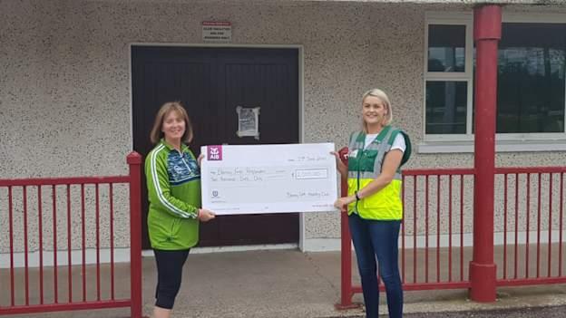 Blarney GAA Healthy Club Committee member, Valerie Kirby, presents a Blarney 500 Mile cheque to Deborah Lynch from Blarney First Responders. 