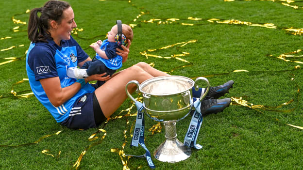 Player of the match Hannah Tyrrell of Dublin celebrates with her daugher Aoife, age 7 weeks, alongside the Brendan Martin Cup after victory in the 2023 TG4 LGFA All-Ireland Senior Championship Final match between Dublin and Kerry at Croke Park in Dublin. Photo by Piaras Ó Mídheach/Sportsfile.