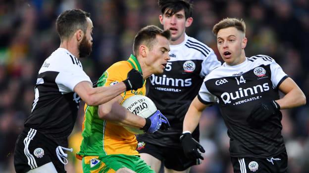 Liam Silke, Corofin, surrounded by Kilcoo's Conor Laverty, Eugene Branagan, and Jerome Johnston during the AIB All Ireland Club Senior Football Championship Final at Croke Park.