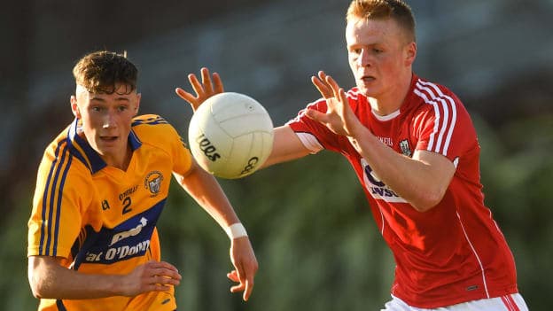 Damien Gore of Cork in action against Jack Sheedy of Clare during the EirGrid Munster GAA Football U20 Championship semi-final.