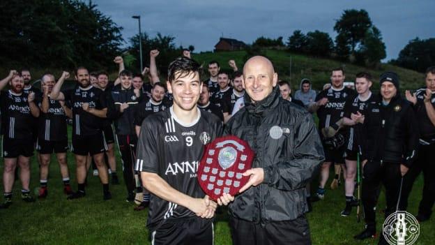 National hurling development manager Martin Fogarty and Omagh St Enda’s captain Tom Mc Clements with the club's first hurling silverware since 1973.