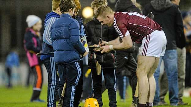 Davy Glennon signs autographs for young hurling supporters at Parnell Park.