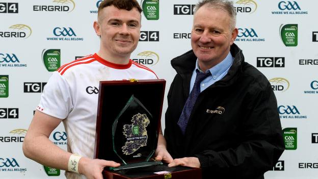 Ethan Jordan of Tyrone receives the Man of the Match Award from Fergal Keenan, EirGrid agricultural liason officer, following the EirGrid Ulster GAA Football U20 Championship Final match between Tyrone and Donegal at St Tiernach's Park in Clones, Monaghan.