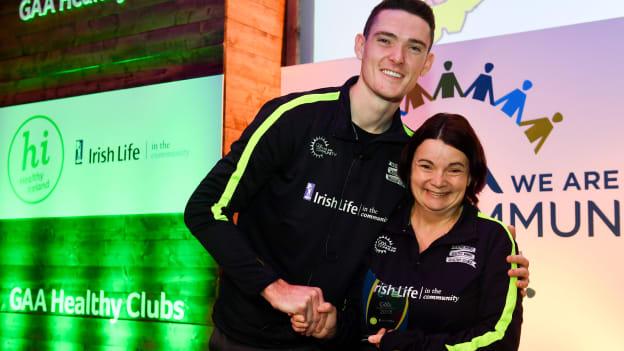 Dublin footballer Brian Fenton presenting Latton O'Rahillys Christina Weldon with her 'Hero Award' at the GAA's Healthy Clubs Conference.