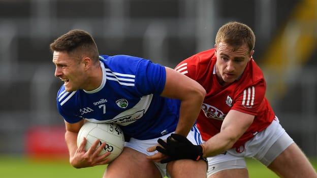 Patrick O'Sullivan, Laois, and Mattie Taylor, Cork, in Allianz Football League action.