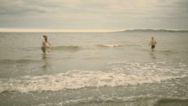 Kila lead singer, Rónán Ó Snodaigh, and former Wexford hurler, Diarmuid Lyng, pictured shooting the video for the song, 'Calling All Angels', on Dublin's Shelley Bank Beach. Photograph by Myles O'Reilly. 