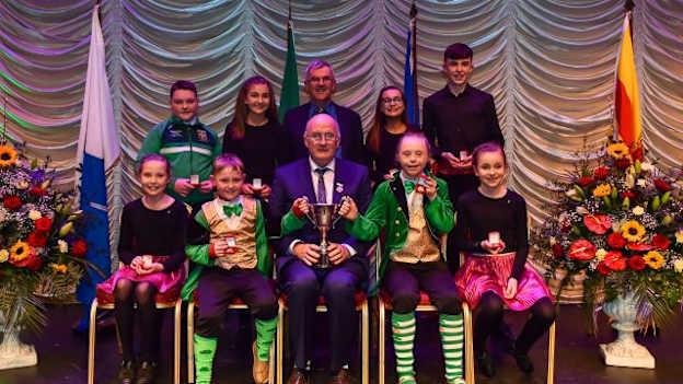 John Horan pictured with the St. Mary's Aghagallon club members who were Léiriú Stáitse/Stage Presentation champions at the 2019 Scór na nÓg. 