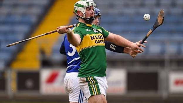 Mikey Boyle, Kerry, shoots to score the 1st goal for Kerry despite the efforts of Darren Maher of Laois.