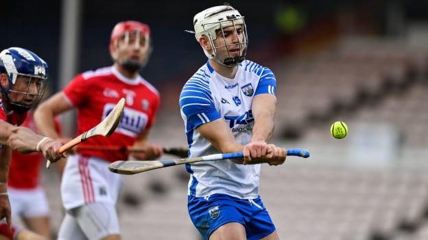 Dessie Hutchinson of Waterford scores a point despite the best efforts of Seán O'Donoghue of Cork during the Munster GAA Hurling Senior Championship Semi-Final match between Cork and Waterford at Semple Stadium in Thurles, Tipperary. 