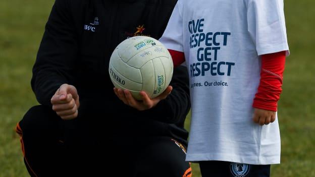 PwC All Star footballer Colm Cavanagh of Tyrone pictured with five year old Dylan O'Kane at a coaching session with juveniles from Philadelphia GAA clubs. 