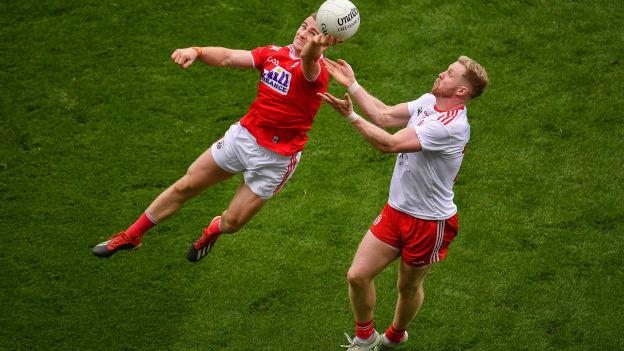 Mattie Taylor of Cork in action against Frank Burns of Tyrone.