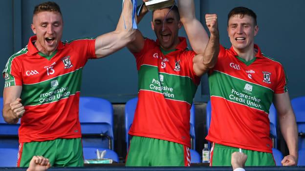 Ballymun Kickhams captain James McCarthy, centre, lifts the Clerys Perpetual Cup alongside Paddy Small, left, and John Small after the Dublin County Senior 1 Football Championship Final match between Ballyboden St Enda's and Ballymun Kickhams at Parnell Park in Dublin. 