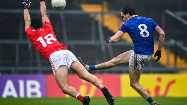 Darren Gallagher of Longford scores a point late in the game despite the efforts of Emmet Carolan of Louth during the Leinster GAA Football Senior Championship Round 1 match between Louth and Longford at TEG Cusack Park in Mullingar, Westmeath. 