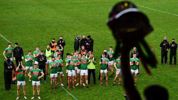 Mayo players look on as captain Aidan O'Shea lifts the cup following the 2020 Connacht GAA Football Senior Championship Final match between Galway and Mayo at Pearse Stadium in Galway.