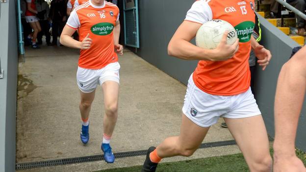 Rian O’Neill of Armagh runs on to the field in front of his brother Oisin O'Neill before the 2019 Ulster GAA Football Senior Championship Semi-Final Replay match between Cavan and Armagh at St Tiarnach's Park in Clones, Monaghan. 