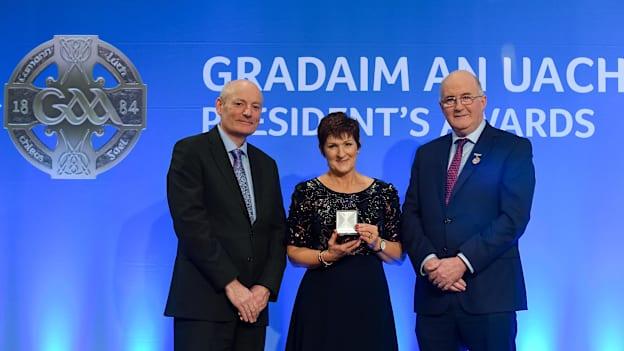 Noreen Corcoran is presented with the Connacht Award by Uachtarán Chumann Lúthchleas Gael John Horan, right, and Denis O'Callaghan, Head of Distribution at AIB, during the 2019 GAA President's Awards at Croke Park. 