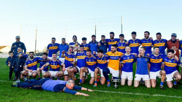St Rynagh's manager Ken Hogan slides in celebration during the team photo with the Sean Robbins Cup after the Offaly County Senior Club Hurling Championship Final match between Coolderry and St Rynagh's at Bord na Mona O'Connor Park in Tullamore, Offaly. 