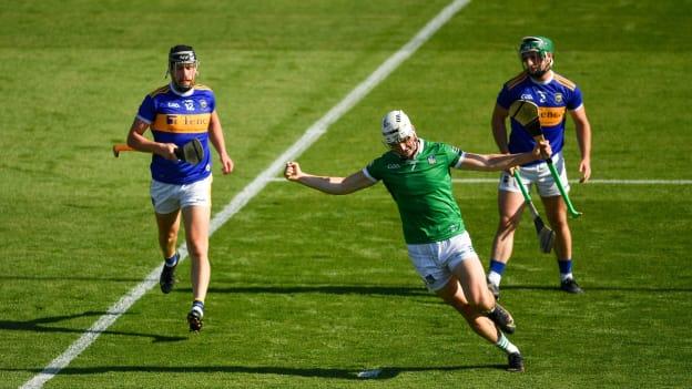 Kyle Hayes of Limerick celebrates scoring his side's second goal , in the 54th minute, as John O'Dwyer, 12, and Cathal Barrett of Tipperary look on, during the Munster GAA Hurling Senior Championship Final match between Limerick and Tipperary at Páirc Uí Chaoimh in Cork. 