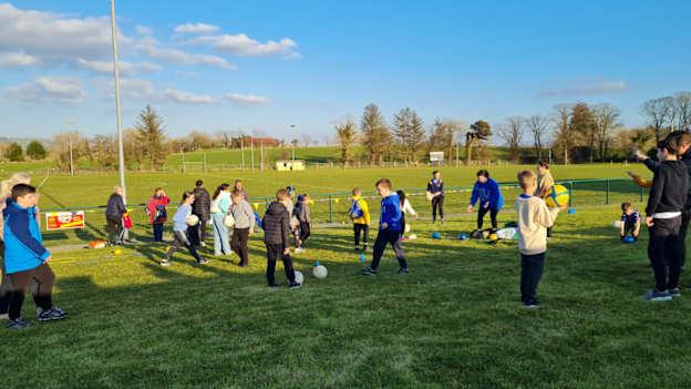 Ukrainian children trying out Gaelic Games at Ballymacelligott GAA club. 