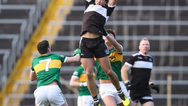 Cian Sheehan of Newcastle West fields a high ball under pressure from Padraic Looram of Clonmel Commercials during the AIB Munster GAA Football Senior Club Championship Semi-Final match between Clonmel Commercials and Newcastle West at FBD Semple Stadium in Thurles, Tipperary.