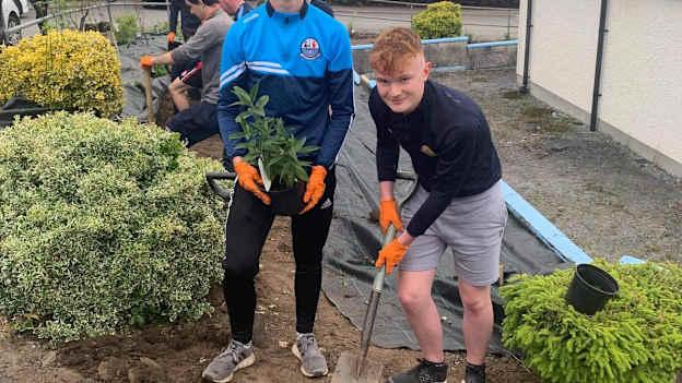 Luke Coyle, right, and fellow Strabane Sigerson club-man, Alex Bishop, planting trees at the club as part of the Dermot Earley Leadership Initiative.