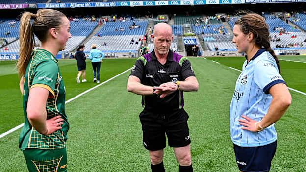Meath captain Aoibhín Cleary and Dublin's Leah Caffrey, along with referee Barry Redmond, ahead of the 2025 TG4 Leinster senior football final. Photo by Piaras Ó Mídheach/Sportsfile
