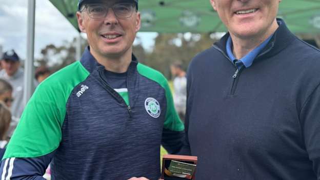 Young Melbourne GAA Club President, Carl Walsh, pictured with GAA President, Jarlath Burns, on his visit to the club in 2024. 