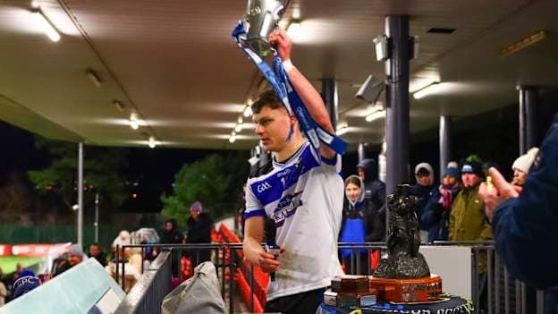 St. Patrick's College, Maghera player, Rian Collins, lifts the Mageean Cup. 