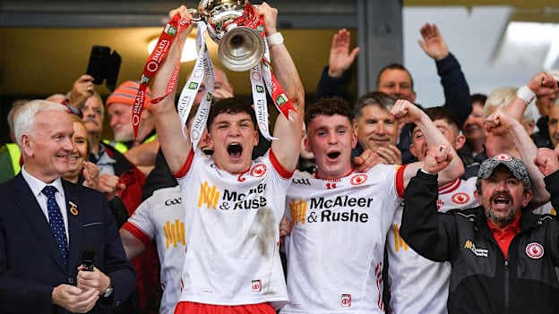 Tyrone captain Joey Clarke, left, lifts the trophy alongside team-mate Eoin McElholm after their side's victory in the 2025 Dalata Hotel Group GAA Football All-Ireland U20 Championship final match between Louth and Tyrone at BOX-IT Athletic Grounds in Armagh. Photo by Oliver McVeigh/Sportsfile