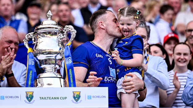 Wicklow captain Dean Healy with his daughter Fiádh after the Tailteann Cup final. Photo by Ben McShane/Sportsfile