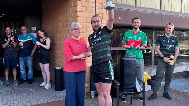 Irish Ambassador to Germany, Maeve Collins, presents the trophy to Pa Joy, Captain of Berlin GAA senior men's football team, at the 2025 GGE Central East Finals