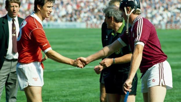 Cork captain Tomás Mulcahy, left, shakes hands with Galway captain Joe Cooney in the presence of referee John Moore before the 1990 All-Ireland SHC Final. 