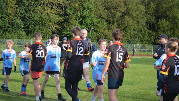 Brussels (black and red jersies) and Luxembourg players exchange handshakes after their match at the GGE European Youth Championships. 