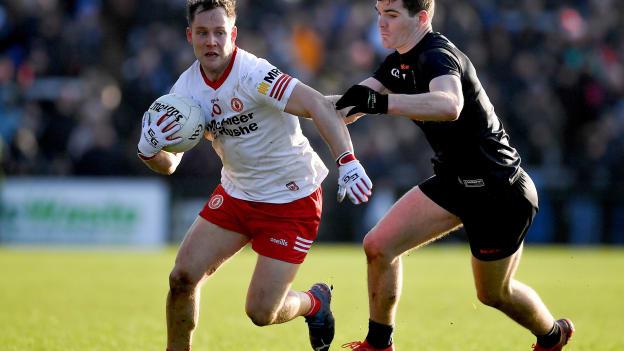 Kieran McGeary of Tyrone is tackled by Jarly Og Burns of Armagh during the Allianz Football League Division 1 match between Armagh and Tyrone at the Athletic Grounds in Armagh.