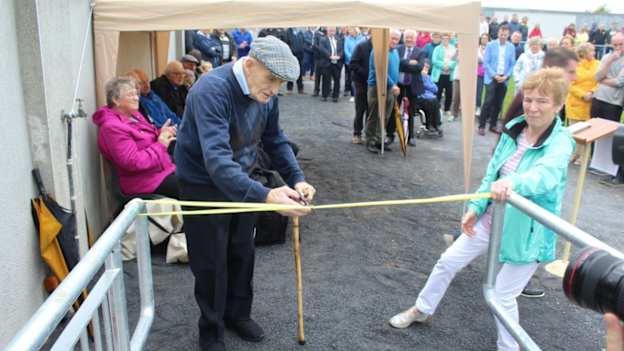 Rosemount GAA Club president, Tom Darcy, cuts the ribbon at the opening of Rosemount GAA's Social Initiative Stand in 2019. 