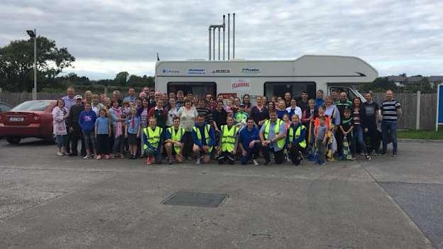 Peter Ryan's and Sean Hahessy's friends, family, and support crew pose for a picture at a rest stop in Clonmel. 